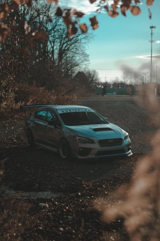 a car parked on the side of a dirt road, inspired by An Gyeon, unsplash contest winner, japanese drift car, ✨🕌🌙, steel gray body, low quality grainy