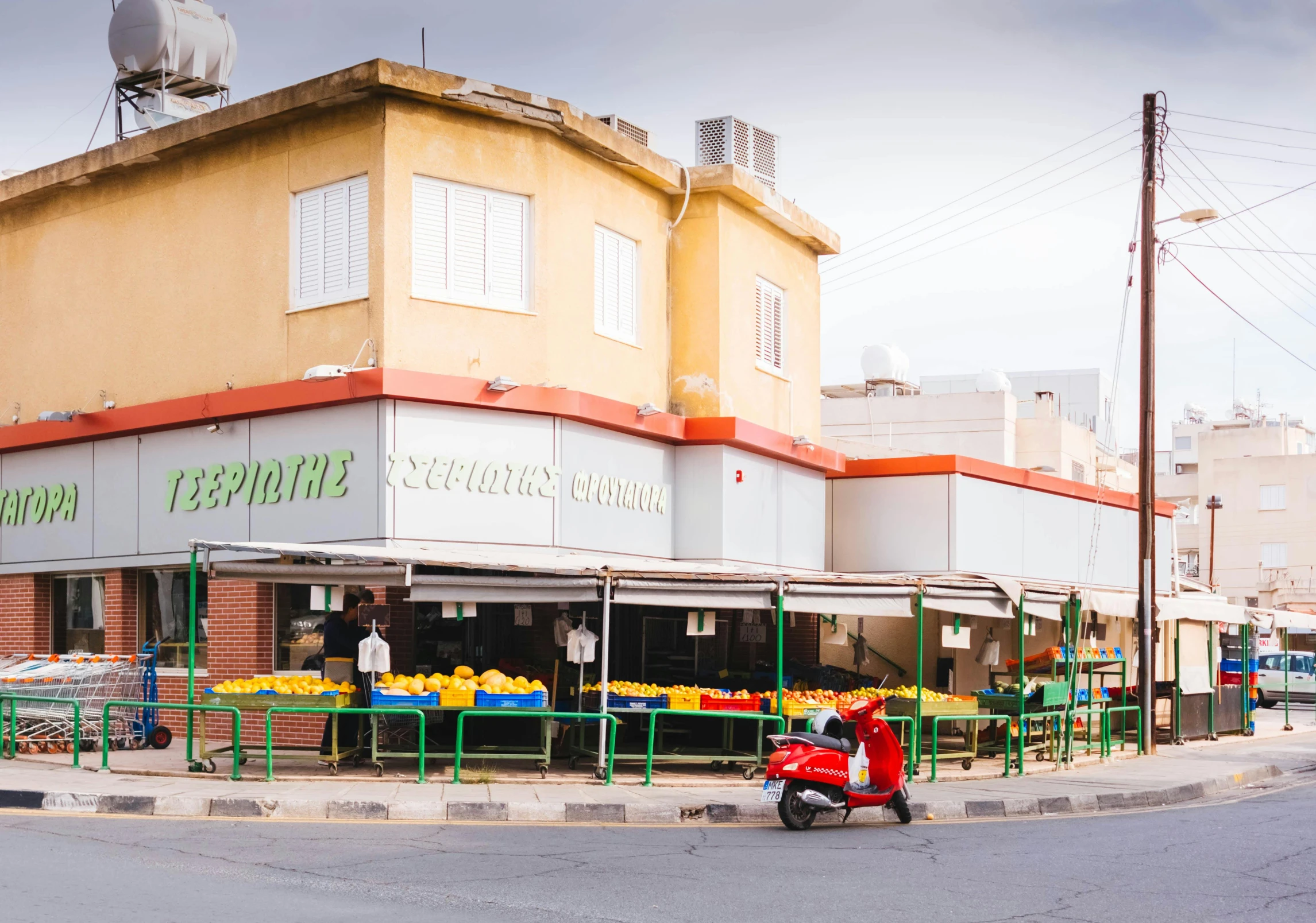 a red scooter parked in front of a store, by Edward Ben Avram, unsplash, cyprus, yellow and green scheme, food stalls, panoramic shot