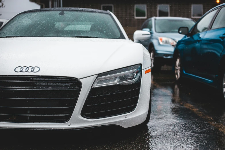 a white car parked next to a blue car, unsplash, sports car, 4 k close up, overcast weather, instagram photo