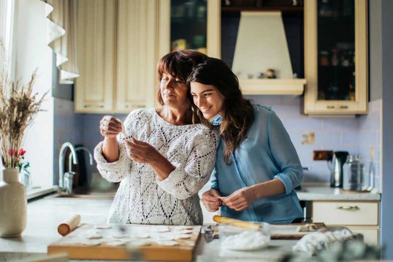 a couple of women standing next to each other in a kitchen, pexels contest winner, renaissance, baking cookies, avatar image, family, phone photo