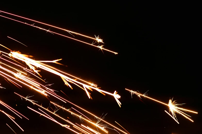 a close up of a person holding a sparkler, auto-destructive art, upper volumetric lightning, some chaotic sparkles, orange spike aura in motion, taken on iphone 14 pro