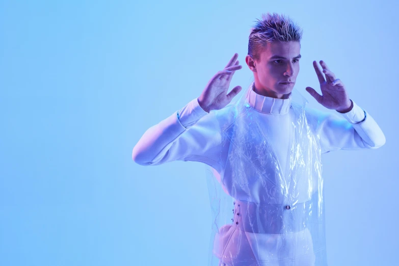 a man that is standing up with his hands in the air, an album cover, inspired by Kristian Kreković, plasticien, wearing futuristic white suit, covered in transparent cloth, non binary model, justin bieber