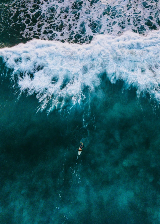 a person riding a surfboard on top of a wave, unsplash contest winner, drone view, manly, profile image, feature