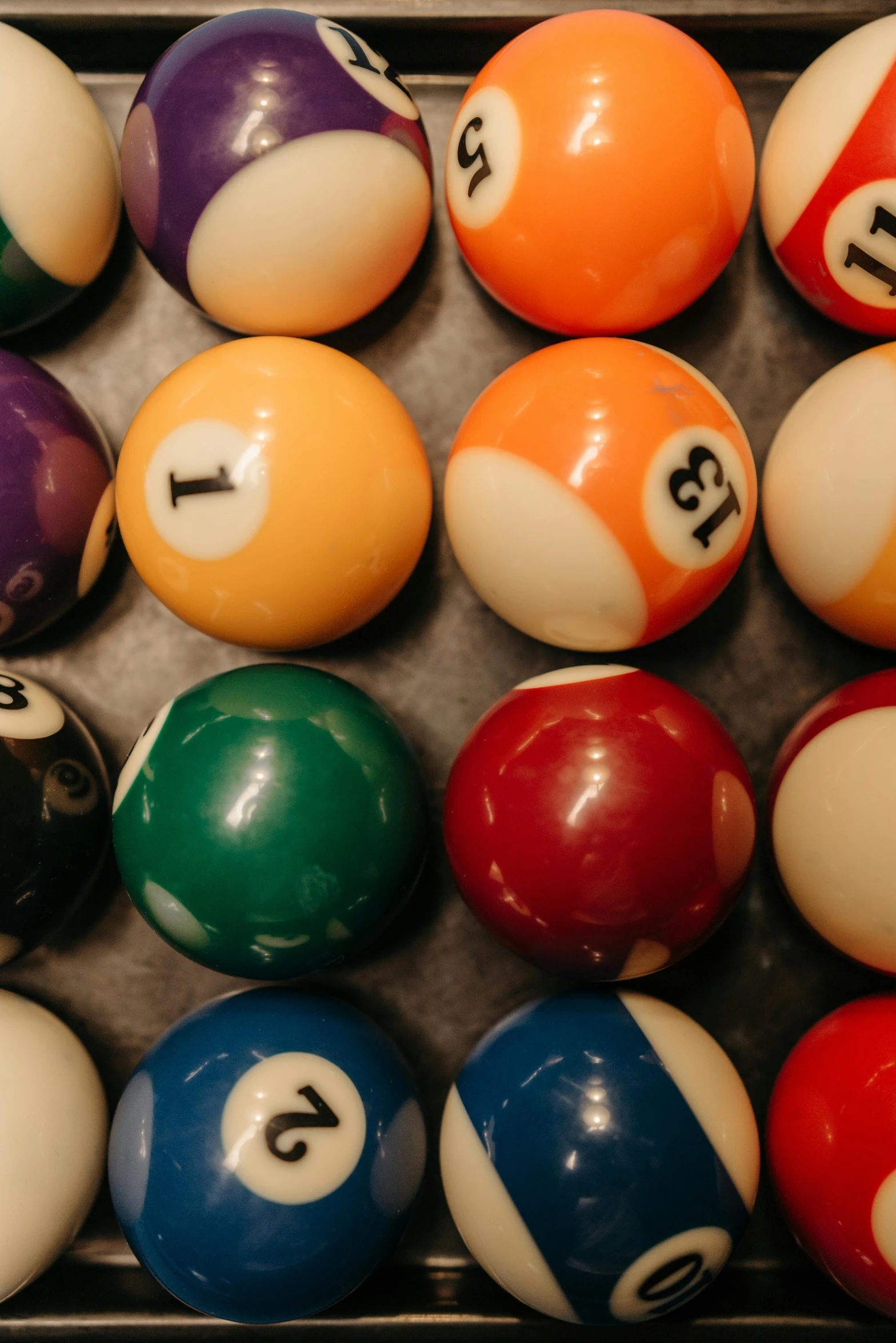 a tray of pool balls sitting on top of a table, by Ben Zoeller, teaser