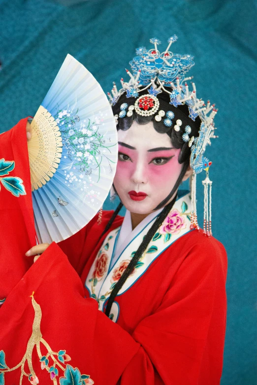 a woman in a red dress holding a fan, inspired by Lan Ying, traditional makeup, wearing a blue robe, 💣 💥💣 💥, square