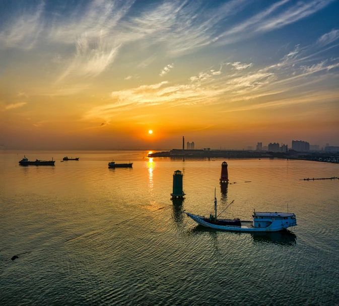 a group of boats floating on top of a body of water, by Jan Tengnagel, pexels contest winner, baotou china, sunset view, harbour, slide show