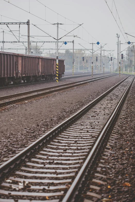 a train traveling down train tracks next to a train station, pexels contest winner, realism, overcast weather, rail tracks lead from the mine, low quality photo, plain background