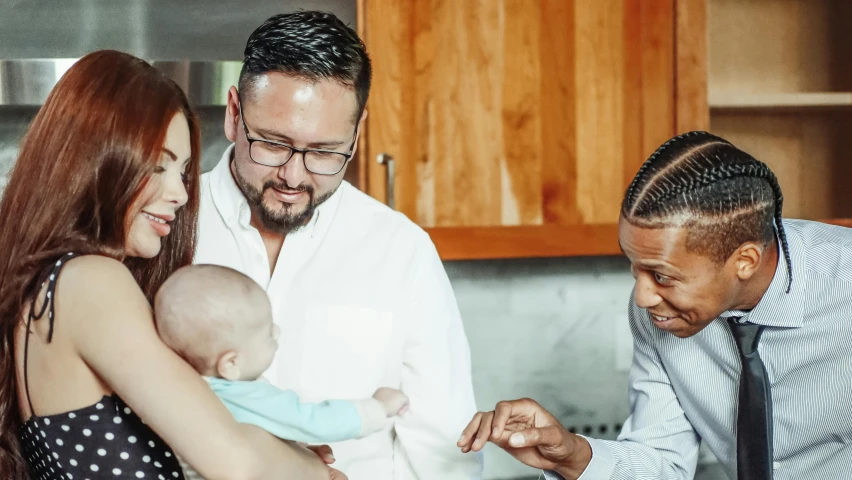 a man standing next to a woman holding a baby, pexels contest winner, signing a bill, mixed race, bowater charlie and brom gerald, thumbnail