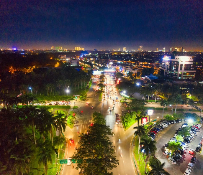 an aerial view of a city at night, pexels contest winner, futuristic phnom-penh cambodia, ultrawide lens”, colombo sri lankan city street, city lights made of lush trees