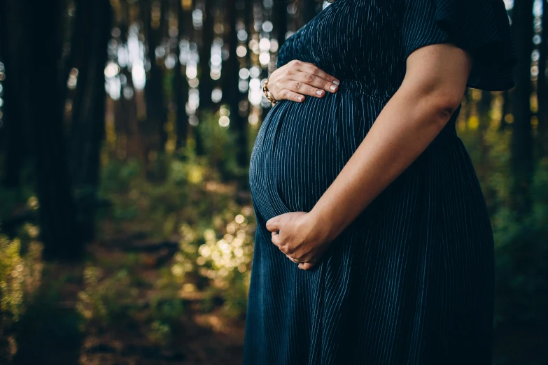 a pregnant woman standing in the woods, pexels, australian, closeup photograph, instagram post, long