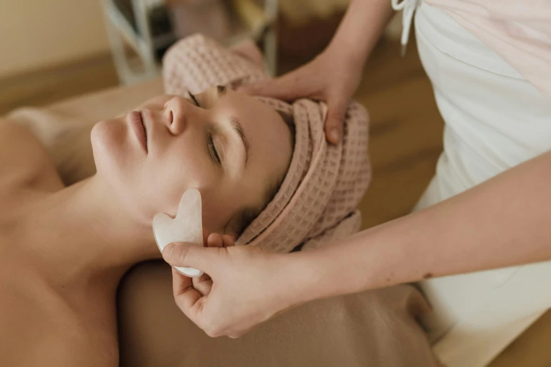 a woman getting a facial massage at a spa, by Emma Andijewska, trending on pexels, cardboard, thumbnail, te pae, skinned