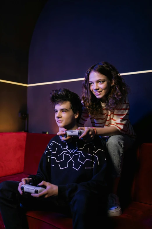 a man and a woman sitting on a couch playing a video game, a portrait, by Adam Marczyński, pexels, renaissance, dafne keen, 15081959 21121991 01012000 4k, studio photo, teenage