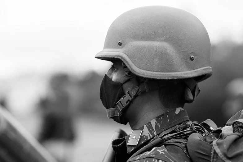 a black and white photo of a soldier with a helmet on, pixabay, wearing facemask, military police, sri lanka, promo image