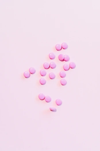 pink pills scattered on a pink surface, by Amelia Peláez, mint, pixvy, minimalist photorealist, chocolate