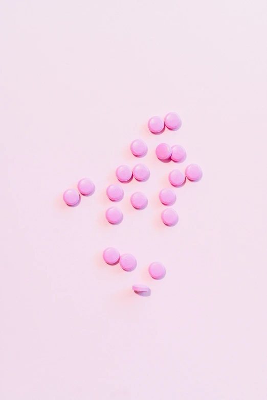 pink pills scattered on a pink surface, by Amelia Peláez, mint, pixvy, minimalist photorealist, chocolate