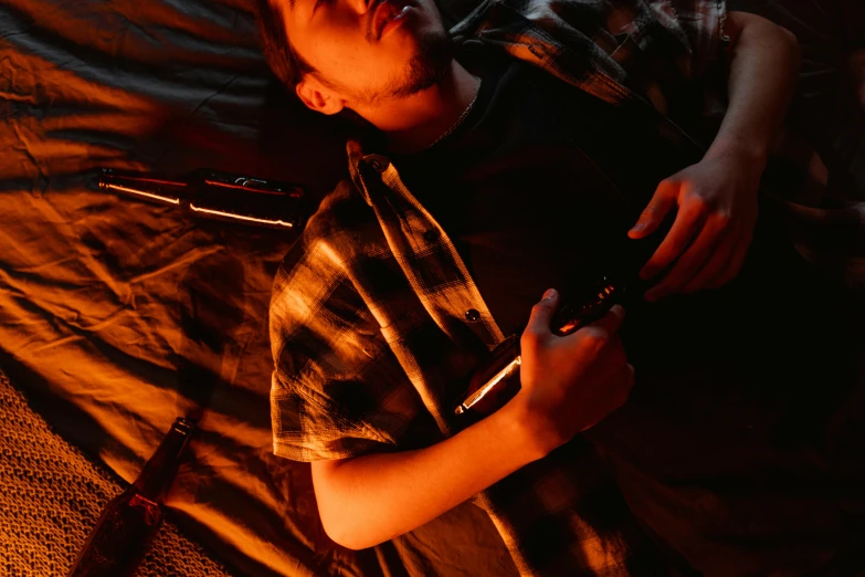 a man laying on a bed holding a cell phone, by Adam Marczyński, pexels, realism, smoking and holding a gun, warm summer nights, gaming, holding a small vape