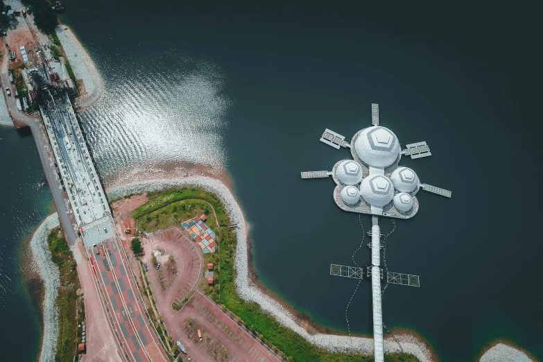 an aerial view of a bridge over a body of water, a digital rendering, pexels contest winner, conceptual art, space elevator, satellite dishes, helipad, erik johansson style