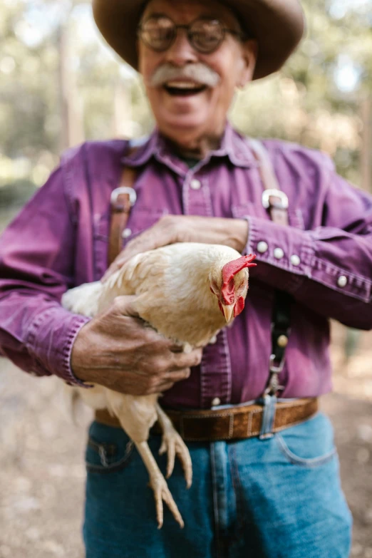 a man in a cowboy hat holding a chicken, unsplash, renaissance, an oldman, florida, where a large, profile image