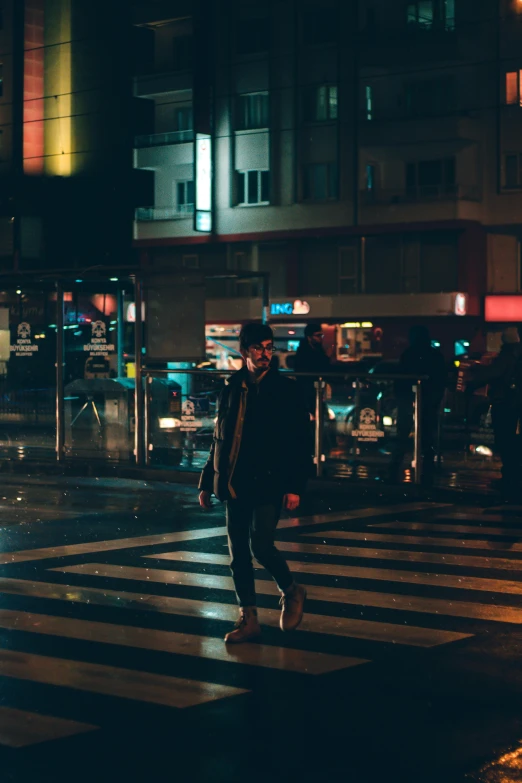 a man walking across a street at night, unsplash contest winner, happening, orelsan, hozier, square, low quality photo