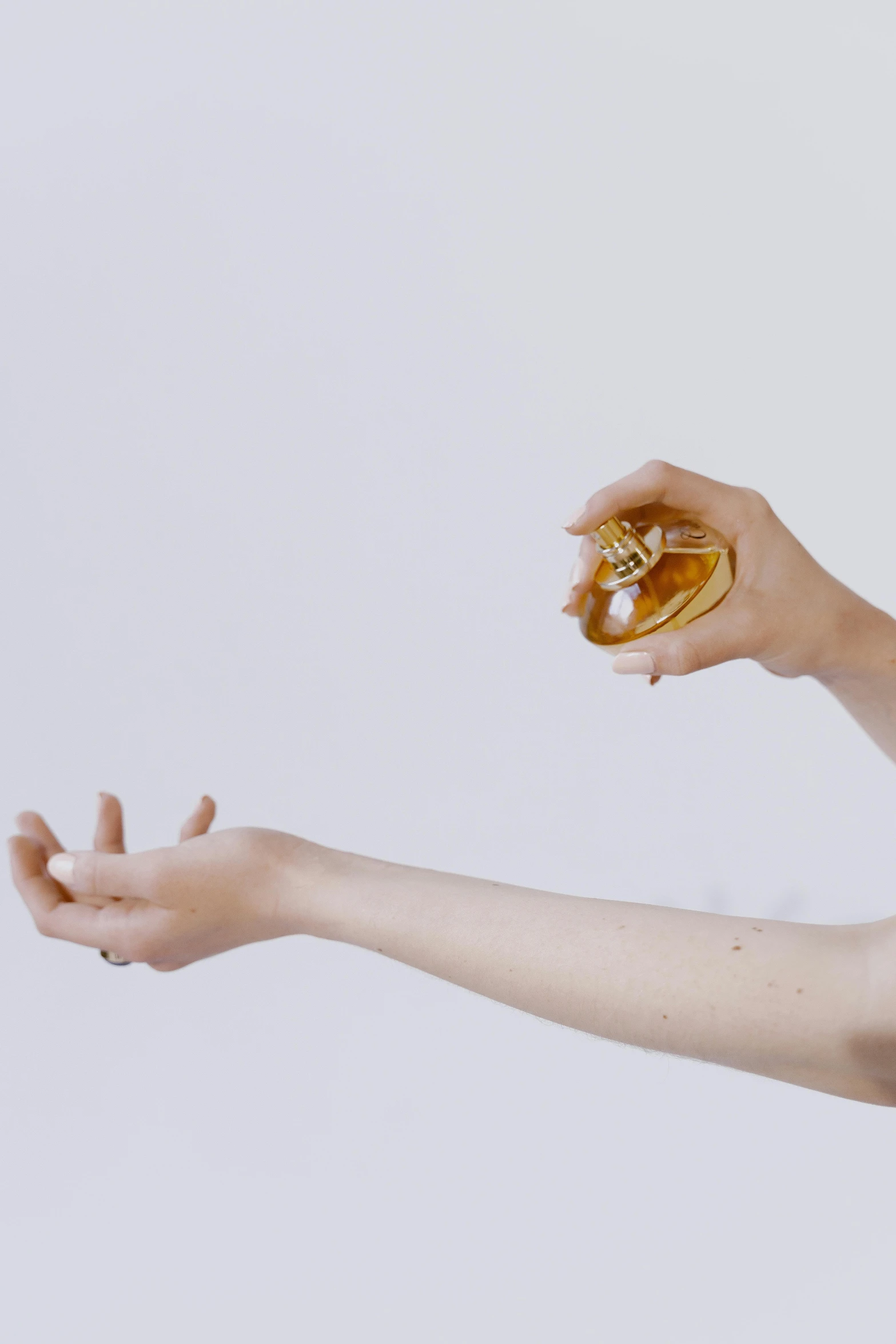 a woman holding a donut in one hand and a donut in the other, a surrealist sculpture, trending on pexels, antique perfume, gold bra, showstudio, emerging hands