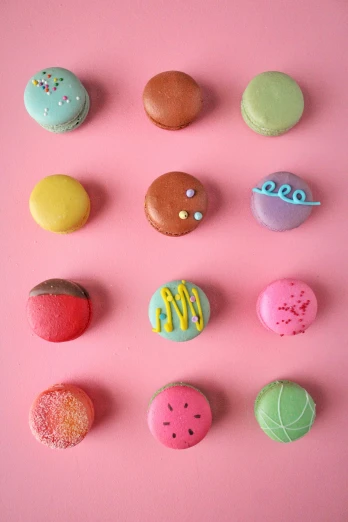a number of doughnuts on a pink surface, a picture, trending on pexels, macaron, multi colour, 15081959 21121991 01012000 4k