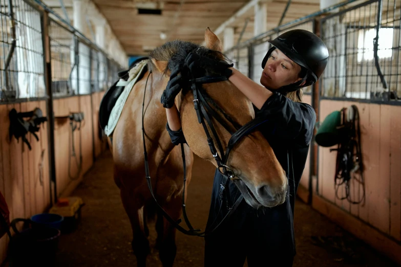 a woman standing next to a horse in a stable, pexels contest winner, wearing her helmet, working hard, thumbnail, inspect in inventory image