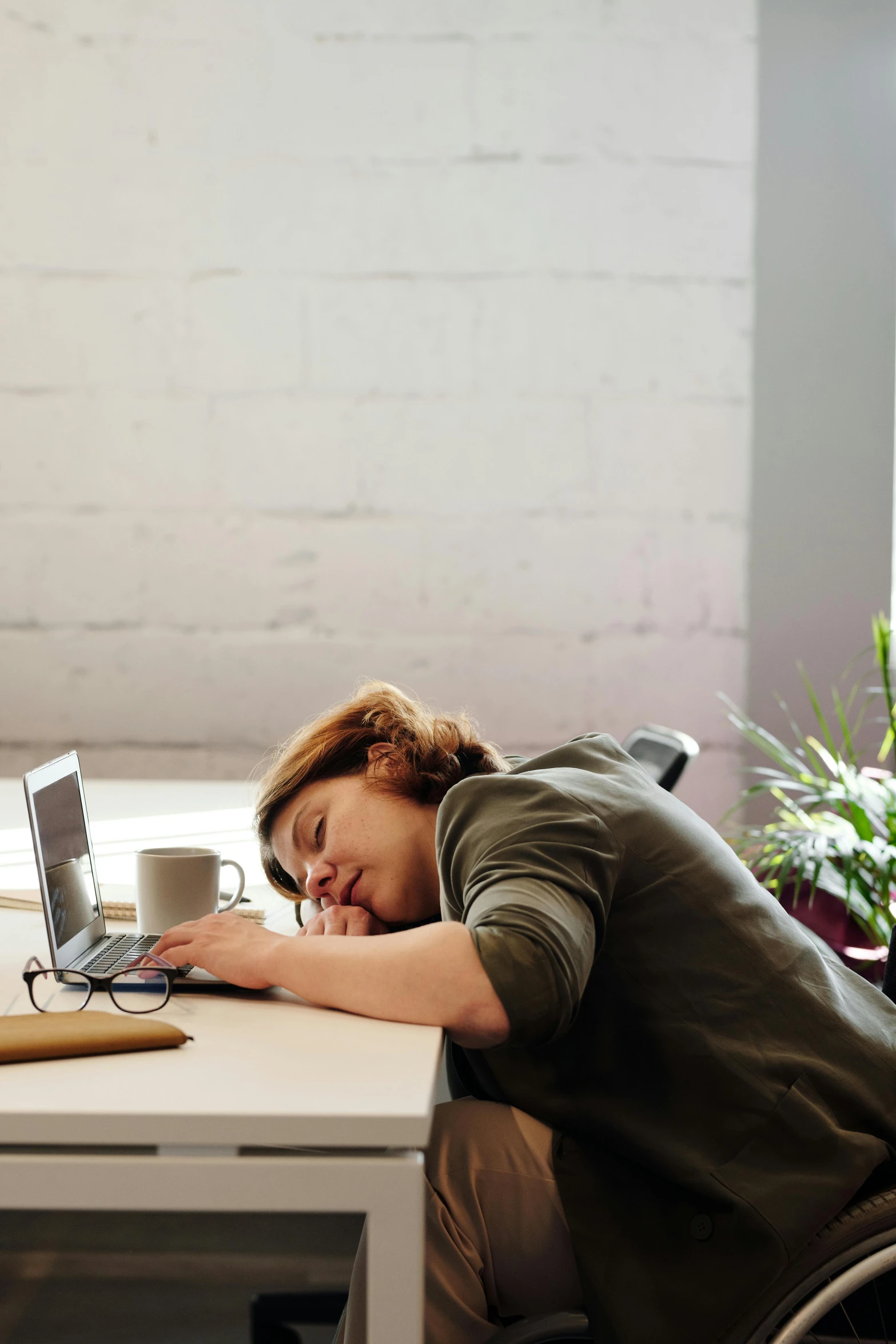 a woman sitting at a desk in front of a laptop computer, pexels contest winner, sleeping, two exhausted, gif, ignant