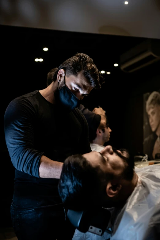 a man getting his hair cut at a barber shop, a portrait, by Derek Chittock, trending on pexels, square masculine jaw, black background hyperrealism, mask off, 1614572159