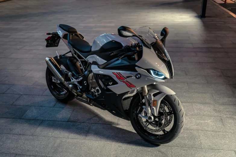 a silver and black motorcycle parked on a sidewalk, lit from the side, bmw, 3 ss max, frontal pose