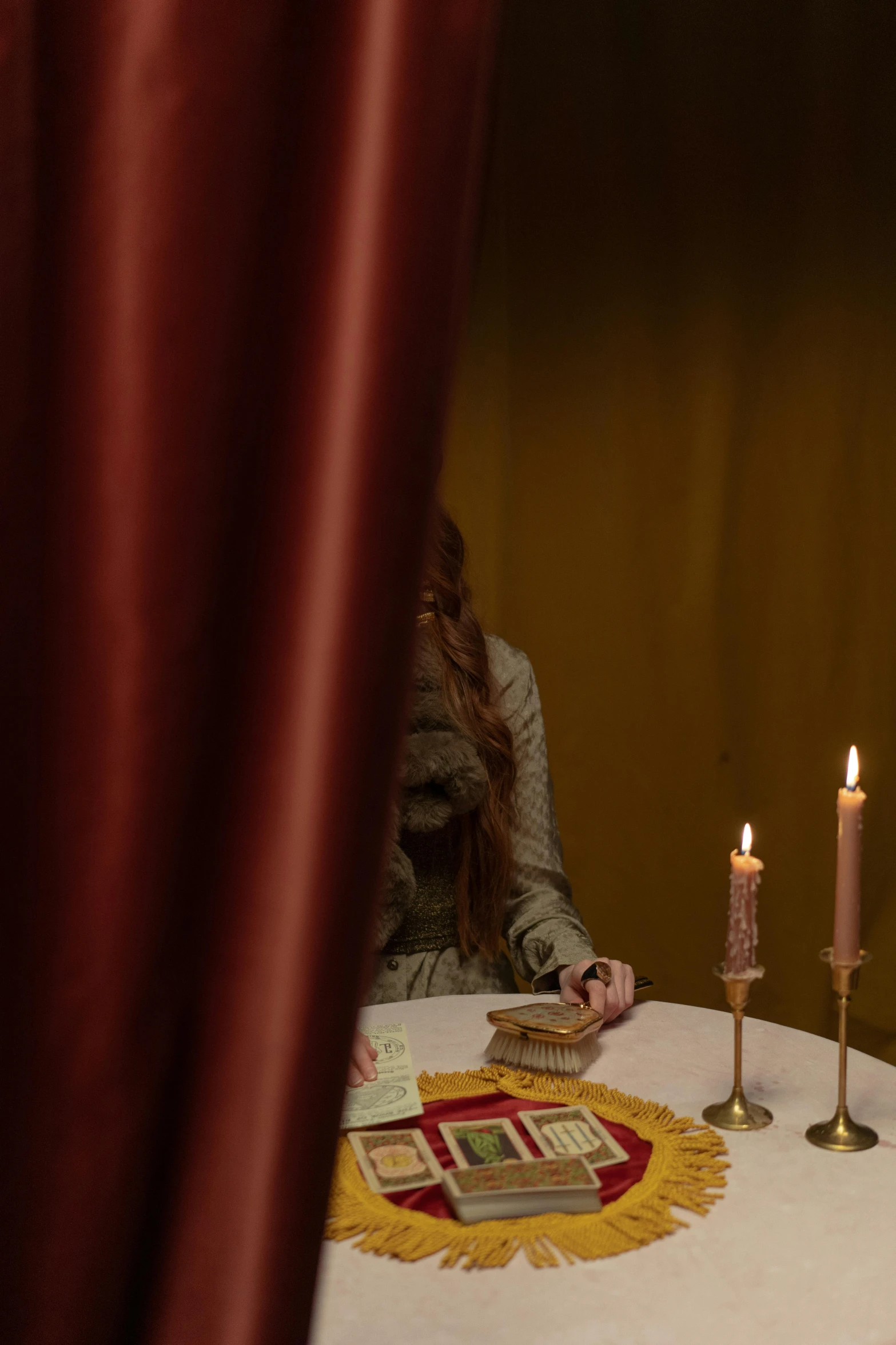 a couple of people sitting at a table with candles, inspired by Pietro Longhi, renaissance, red curtain, alessio albi, lot of details, production photo