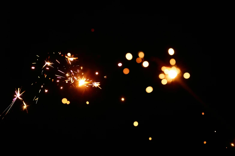 a couple of sparklers that are in the dark, light and space, flashing lights, with sparking circuits, lit from the side