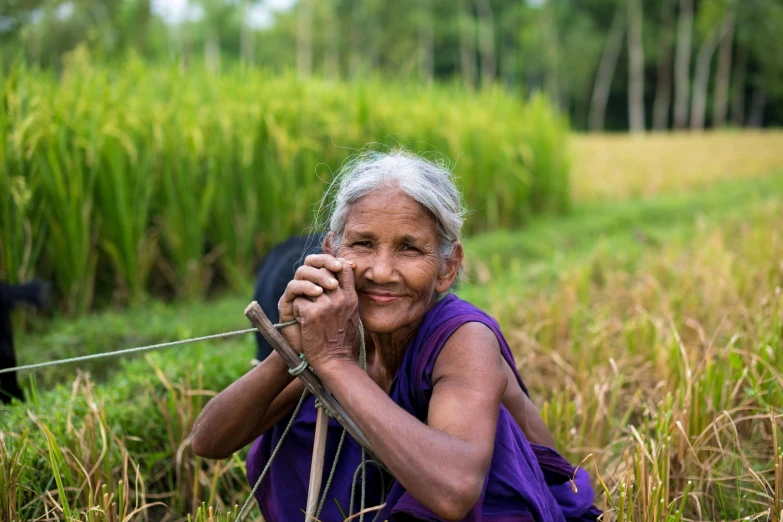 a woman sitting in the middle of a field, a portrait, pexels contest winner, sumatraism, welcoming grin, sri lanka, avatar image, farming