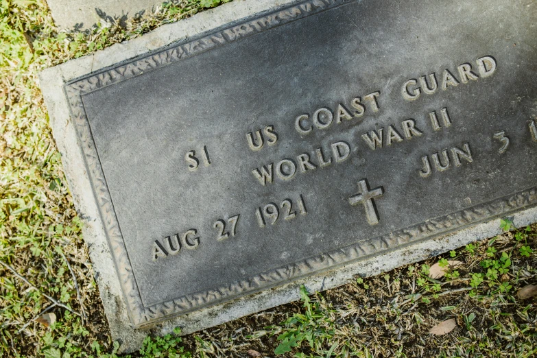 a plaque that says us coast guard world war ii, a portrait, unsplash, the graveyard, yet unrecognizable, trending photo