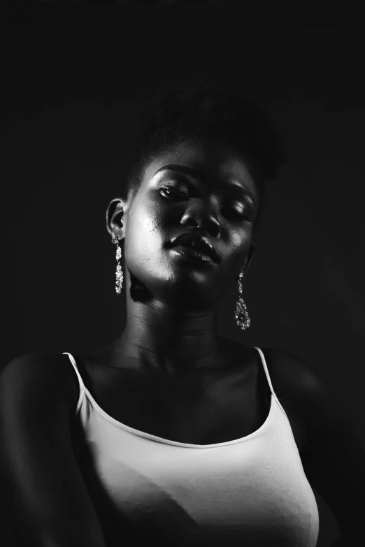 a black and white photo of a woman in a tank top, by Lily Delissa Joseph, pexels contest winner, afrofuturism, girl with a pearl earringl, dark black porcelain skin, adut akech, lightening