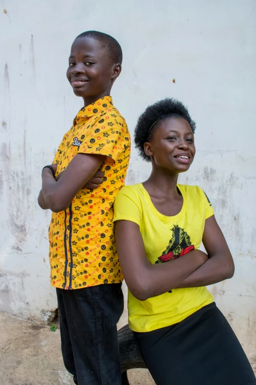 a couple of people standing next to each other, by Ingrida Kadaka, happening, wearing shirts, teenager, posed, uncropped