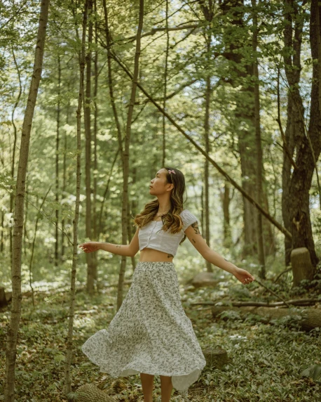 a woman standing in the middle of a forest, wearing a tanktop and skirt, flower child, ((forest))