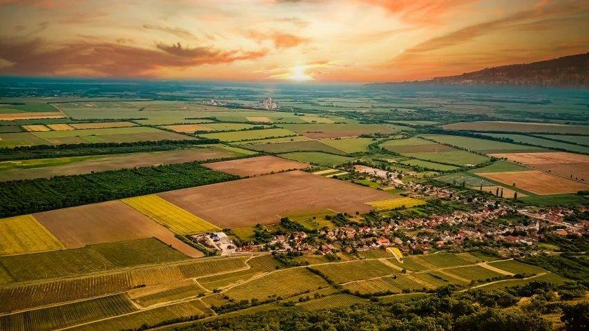 an aerial view of the countryside at sunset, by Matthias Stom, shutterstock, renaissance, pur champagne damery, urban surroundings, maintenance photo