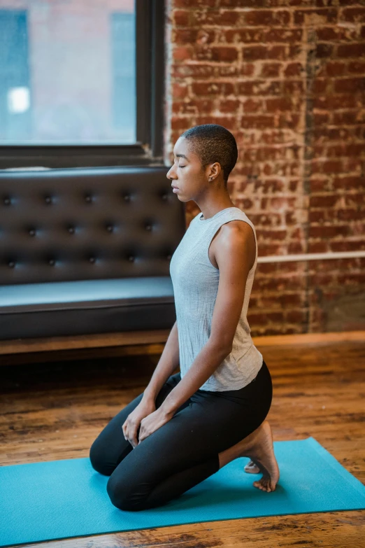 a woman sitting on a yoga mat in a living room, by Carey Morris, pexels contest winner, renaissance, squatting pose, profile image, ashteroth, arched back