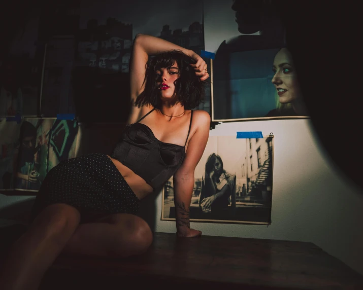 a woman posing for a picture in a dark room, a picture, inspired by Nan Goldin, pexels contest winner, art photography, wearing crop top and miniskirt, in an art gallery], brunette woman, in a bedroom