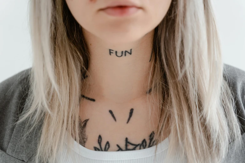 a woman with a tattoo on her neck, trending on pexels, funny jumbled letters, fair skin, wearing collar, fun