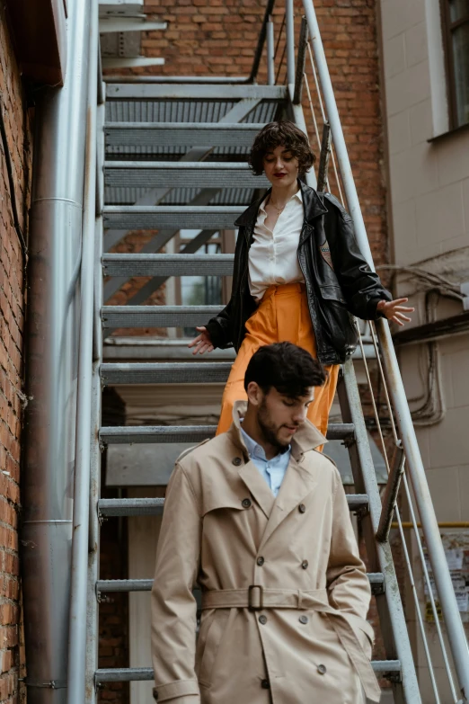 a man and a woman walking up a set of stairs, trending on pexels, renaissance, leather trench coat, thumbnail, portrait image, retro and 1 9 8 0 s style