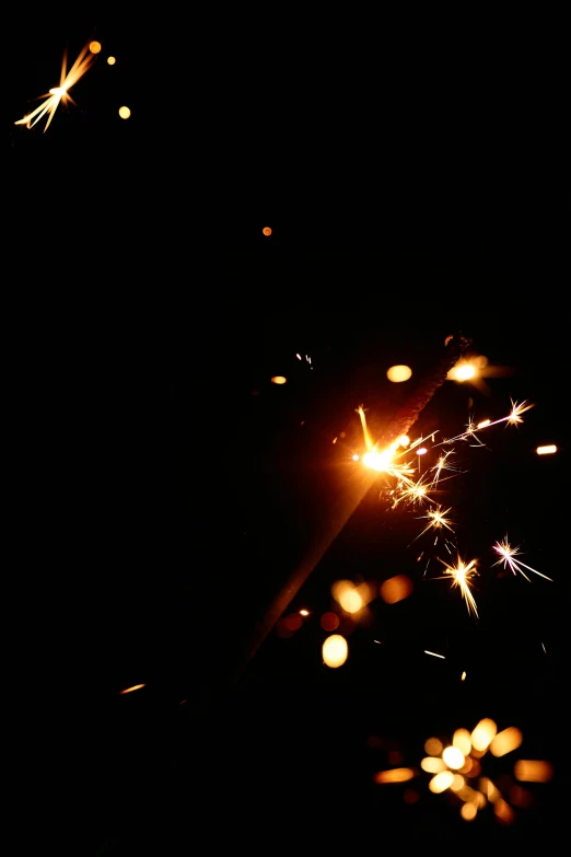 a close up of a sparkler in the dark, an album cover, pexels, light and space, metalwork, scratches and burns on film, a brightly colored, ilustration