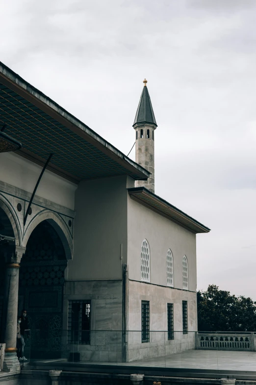 a building with a clock tower next to a body of water, a marble sculpture, inspired by Altoon Sultan, hurufiyya, trending on vsco, ottoman empire, high arched ceiling, side elevation