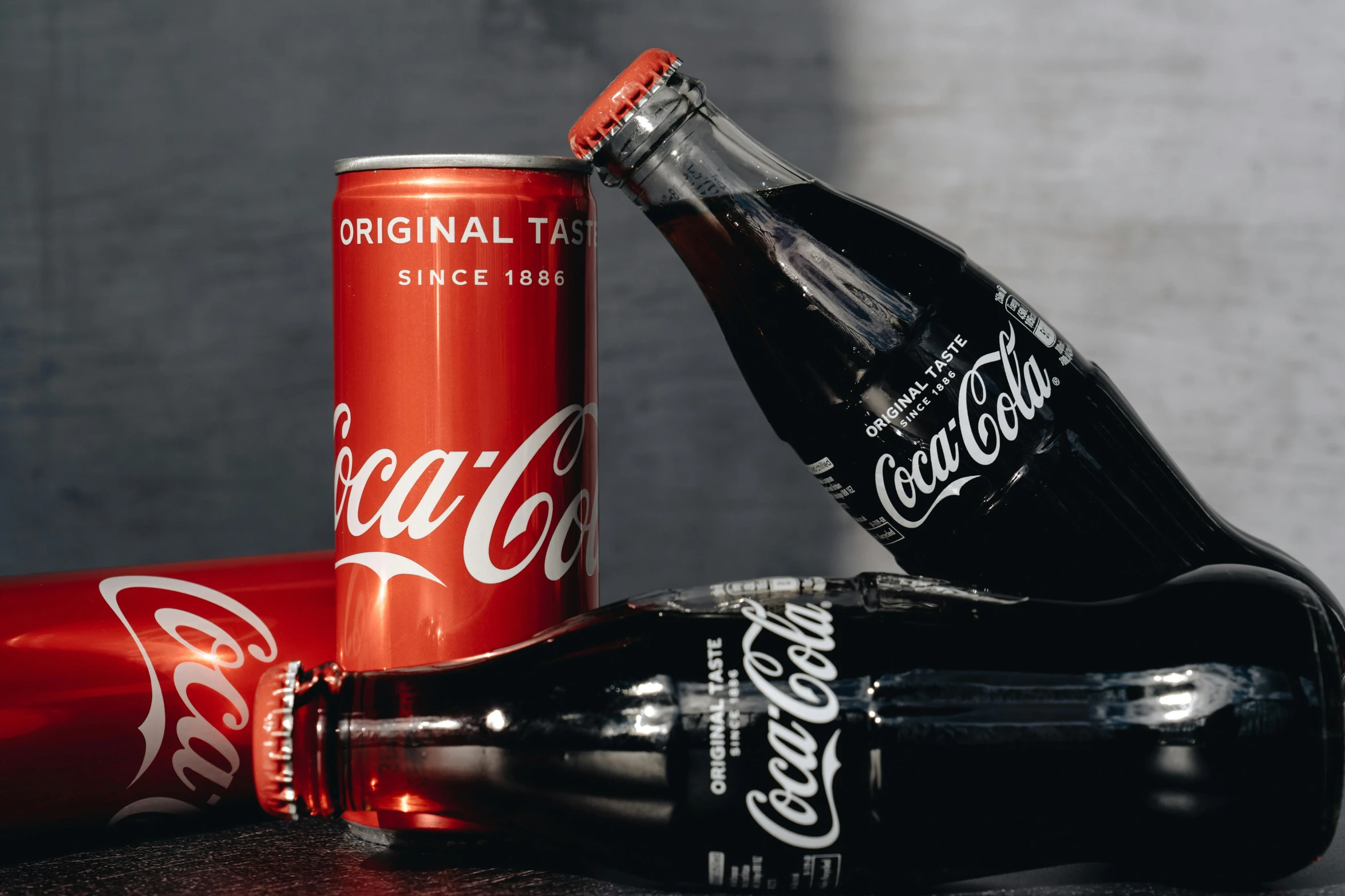 a couple of coke bottles sitting on top of a table, on a black background, high quality product image”, reds), thumbnail