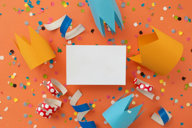 a paper crown surrounded by confetti on an orange background, by Helen Stevenson, pexels contest winner, cardboard tunnels, whiteboards, floating objects, birthday card