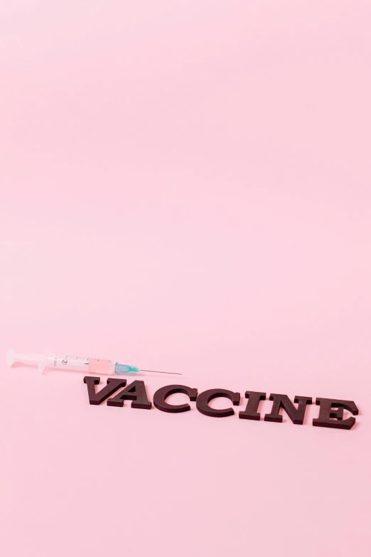 a toothbrush sitting on top of a pink surface, an album cover, by Caro Niederer, pexels contest winner, visual art, holding a syringe!!, 8 0. lv, virus, sign