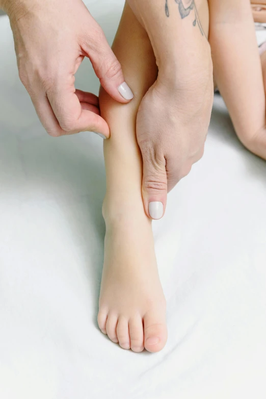 a woman has a tattoo on her leg, by Victorine Foot, dribble, soft volume absorbation, partially cupping her hands, lynn skordal, children's