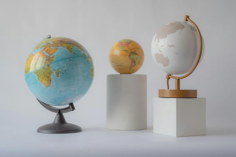 a group of three globes sitting next to each other, full product shot, unique styles, 3 d print, fan favorite