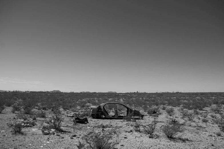 a black and white photo of a car in the desert, auto-destructive art, space ship cemetery outer space, 8k octan photo, photos, unsplash contest winning photo