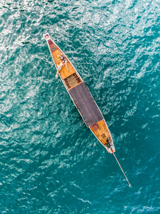 a small boat floating on top of a large body of water, a high angle shot, gondola, thumbnail, sri lanka